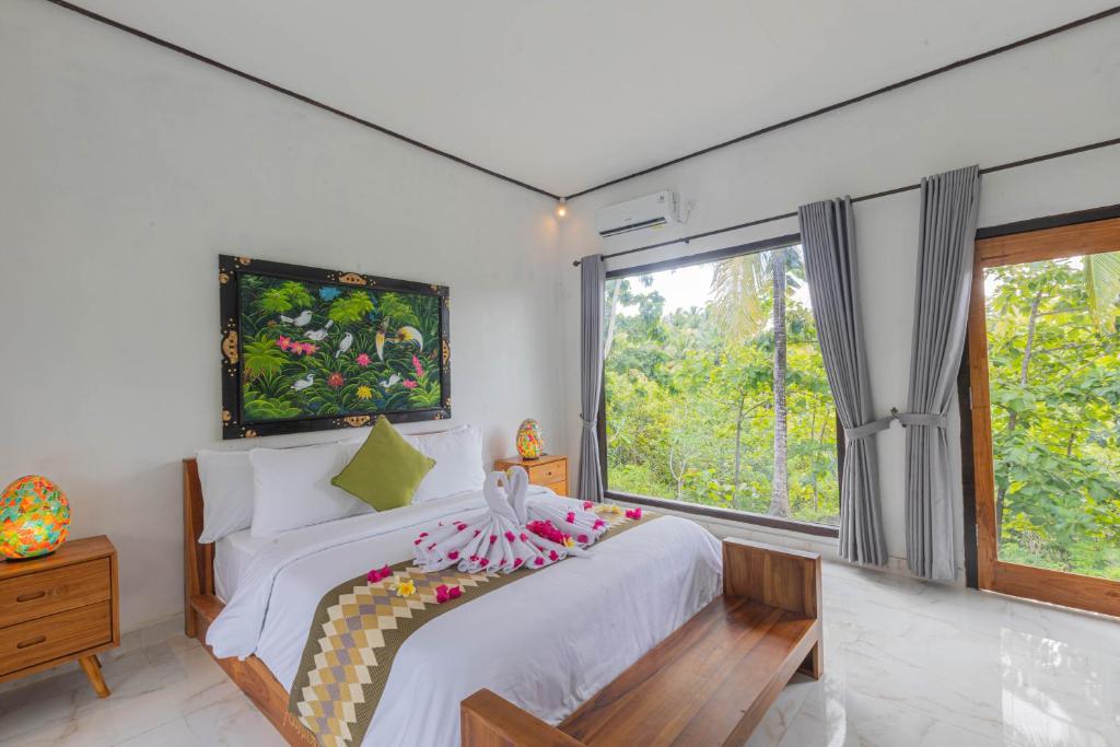 Cama ou camas em um quarto em Radjes Bungalow Nusa Penida