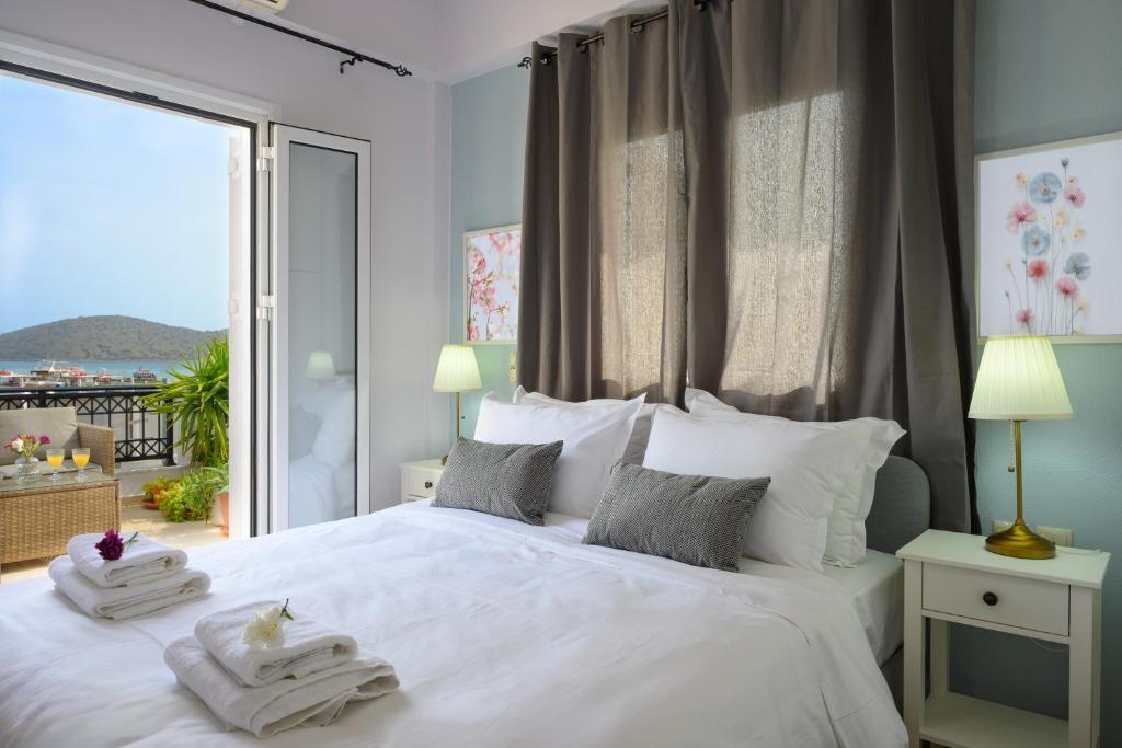 A bed or beds in a room at Elounda Luso Apartment