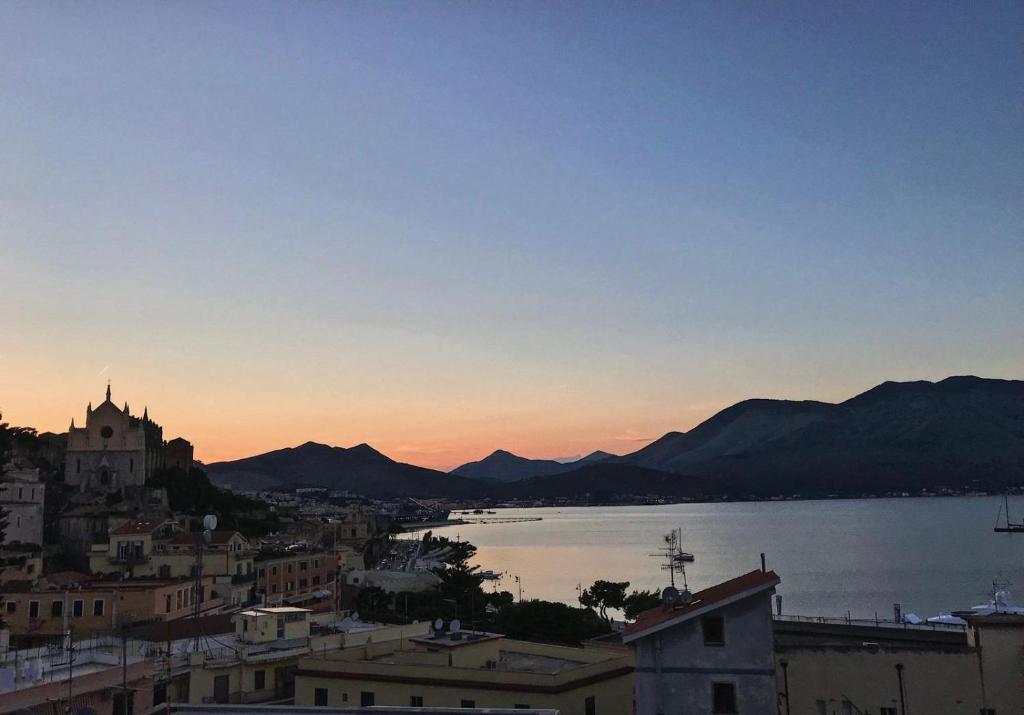 a view of a city and a lake at sunset at Il Girasole in Gaeta