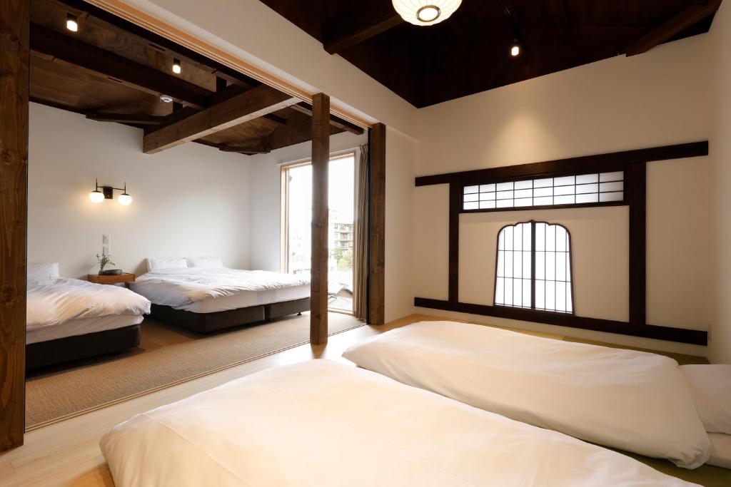 A bed or beds in a room at 貸別荘 楓-Fū- 有馬