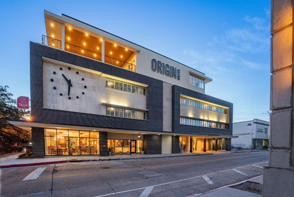 Un edificio con un orologio sulla parte anteriore di Origin Baton Rouge, a Wyndham Hotel a Baton Rouge