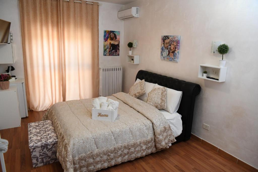 a bedroom with a bed with a box on it at Casa Donna di Cuori in Fiumicino