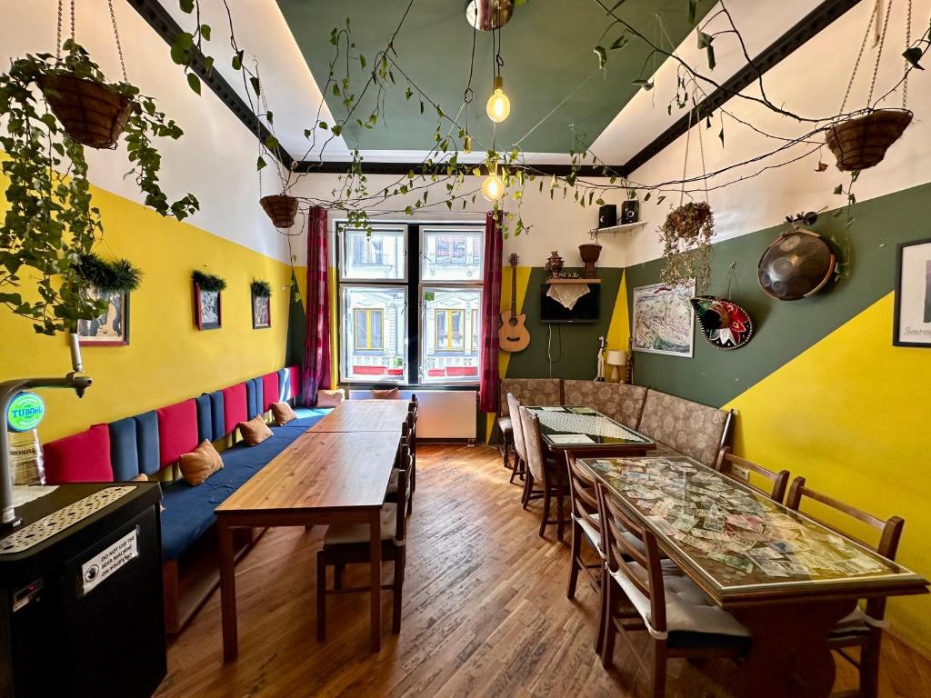 a room with tables and chairs in a restaurant at Hostel Vagabond in Sarajevo