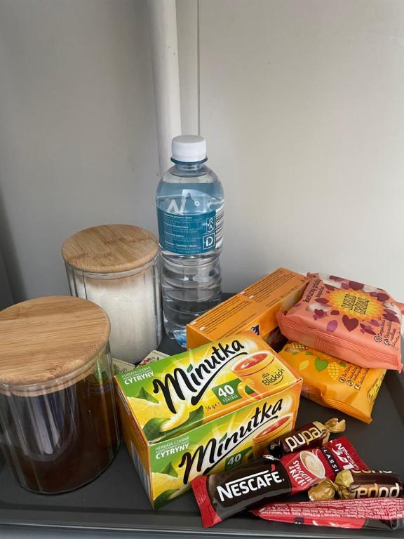 a refrigerator shelf with snacks and a bottle of water at Parko apartamentai in Panevėžys