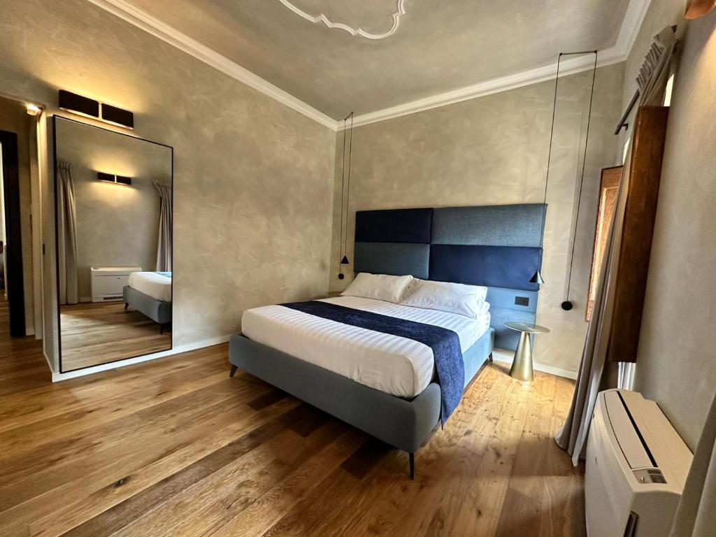 a bedroom with a bed and a large mirror at Residenza Leutari in Rome