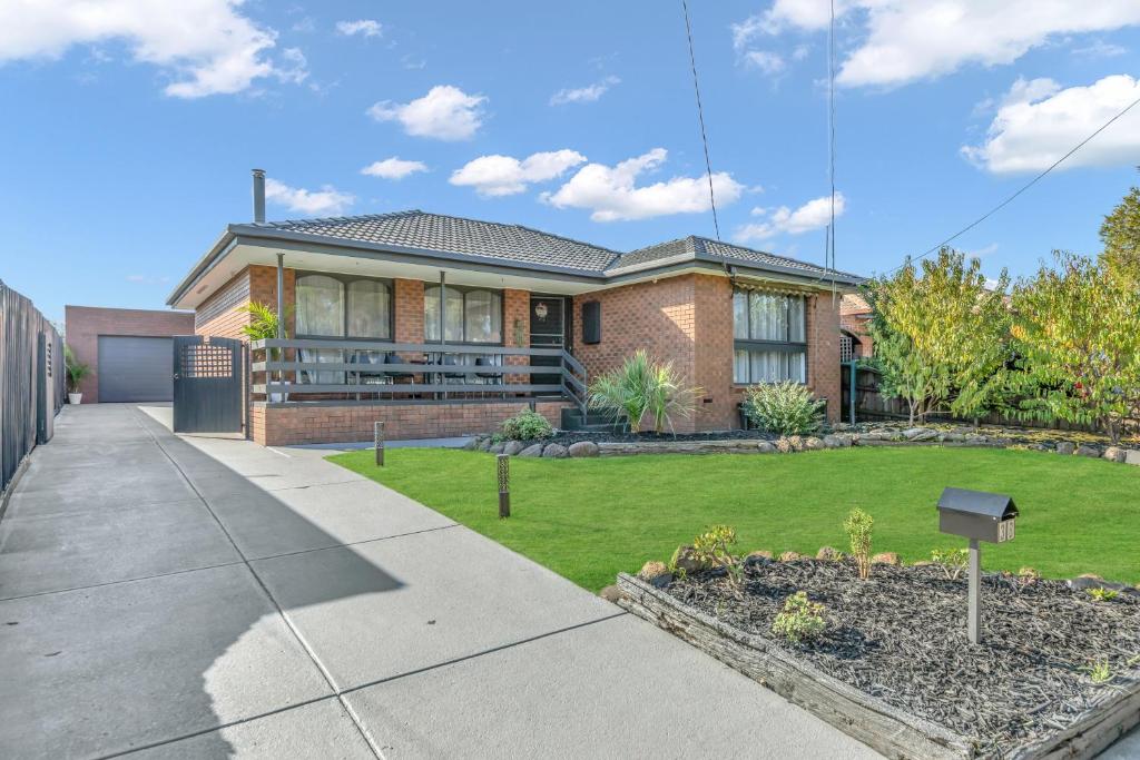 a brick house with a lawn in front of it at Newly Renovated House near Melbourne Airport in Melbourne