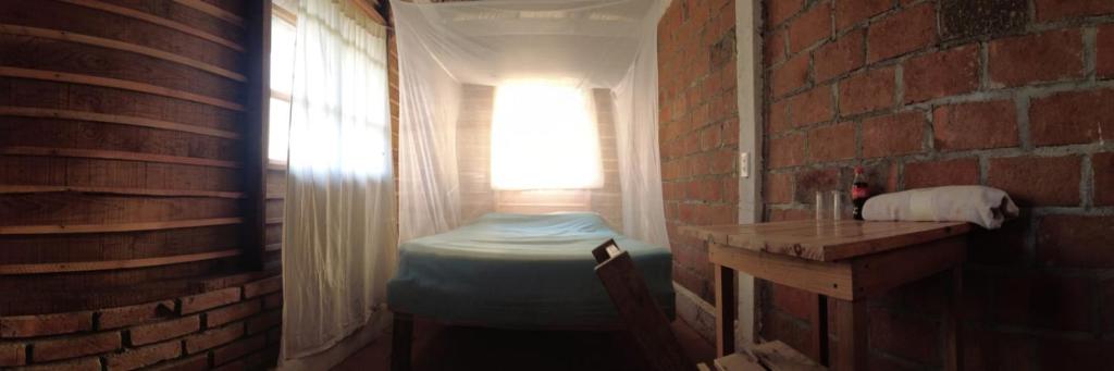 A bed or beds in a room at hostal pakal