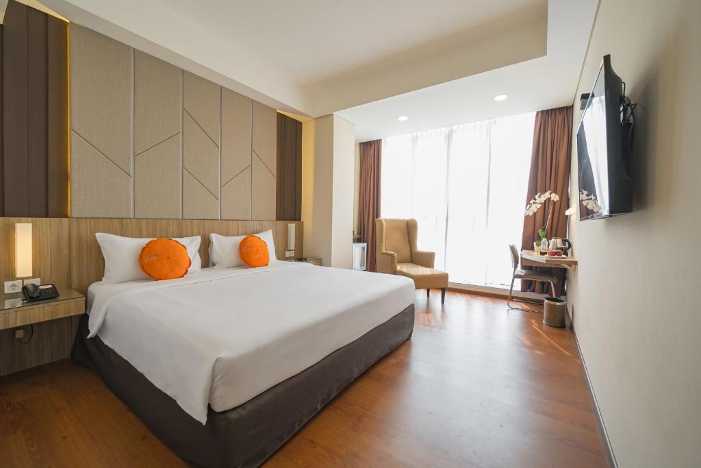 Una cama o camas en una habitación de Grand G7 Hotel Pasar baru