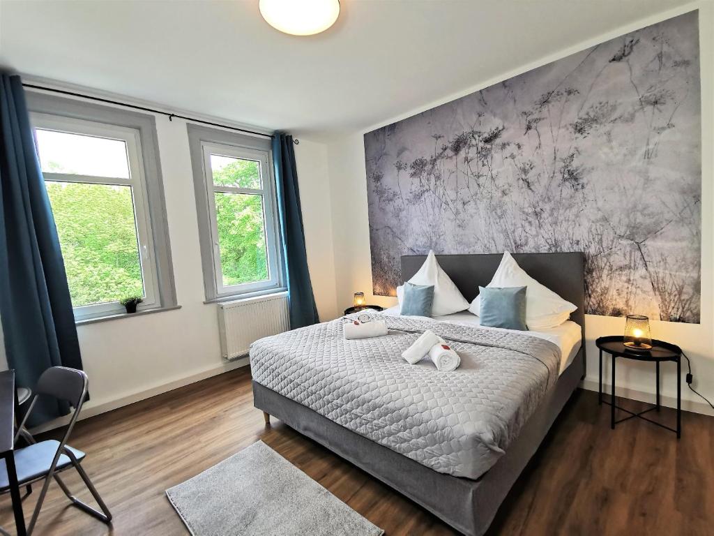 Kama o mga kama sa kuwarto sa BohnApartments - Stadtblick Zechenhaus - Balkon - gratis Parkplatz - WLAN - sehr ruhig - barrierearm