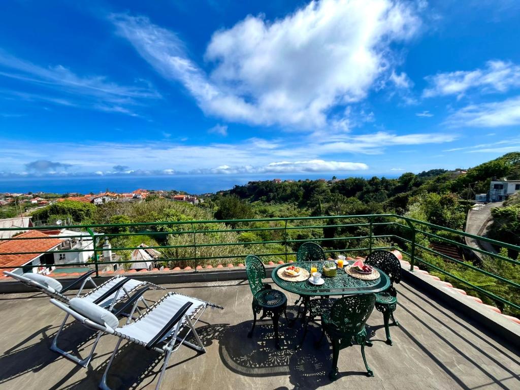 a patio with a table and chairs on a balcony at Villa Garden Santana by Your Key in Santana