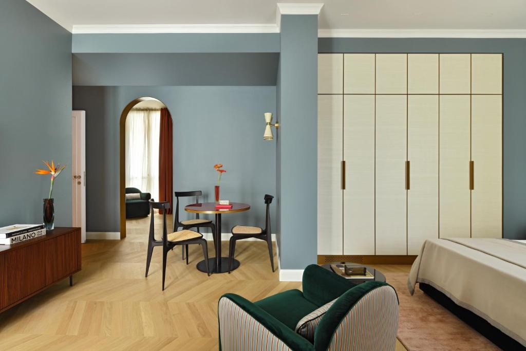 a bedroom with a bed and a table and chairs at Casa Brivio in Milan