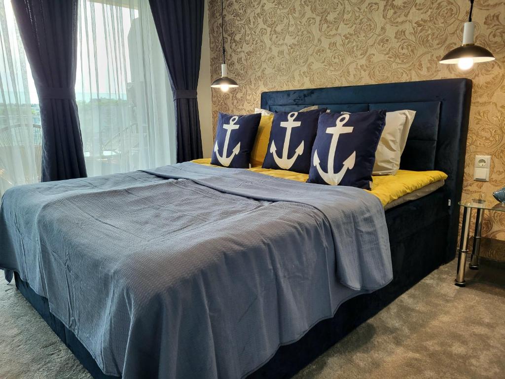 a blue bed with pillows on it in a bedroom at Sea view luxury appartment in Varna City