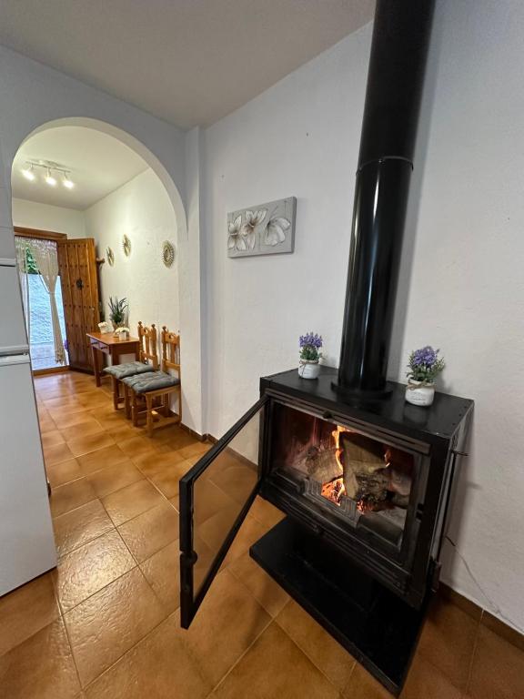 a living room with a fireplace in a house at Las Vistas in Bubión