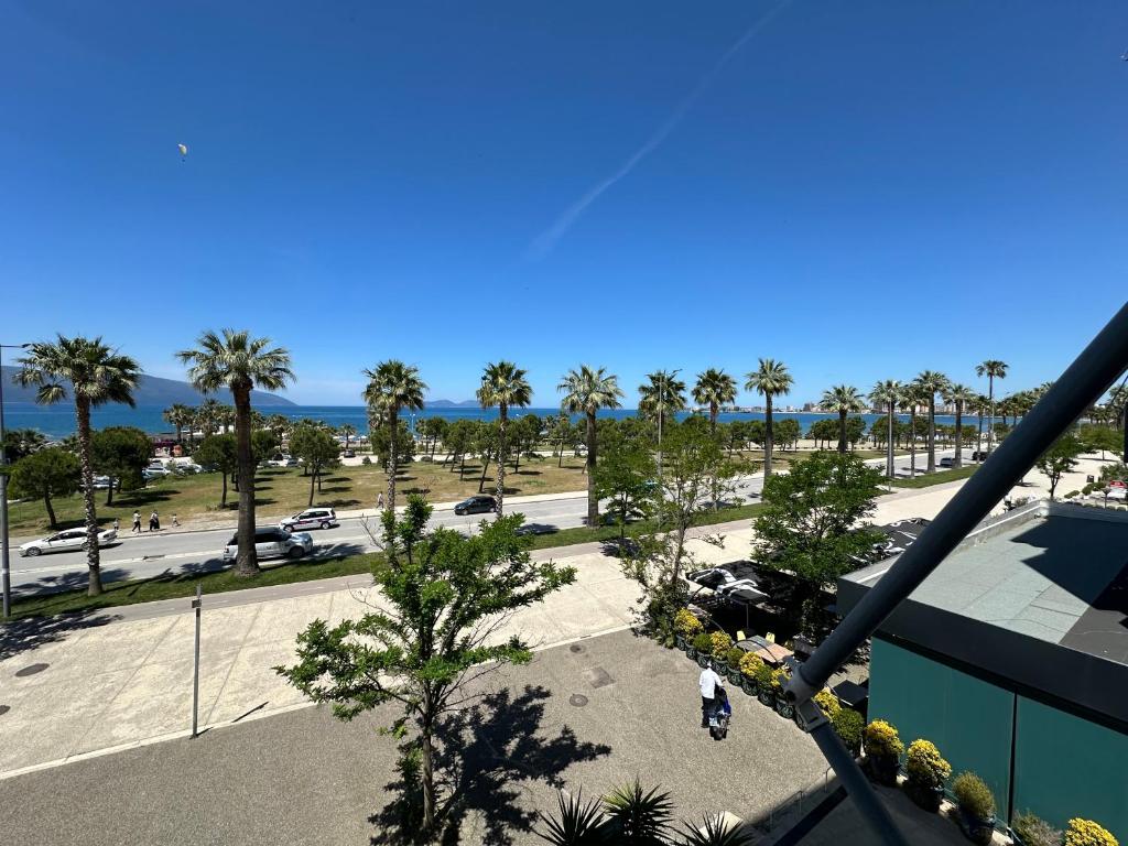 a view of a parking lot with palm trees at Luxury Sea View Apartment in Vlorë