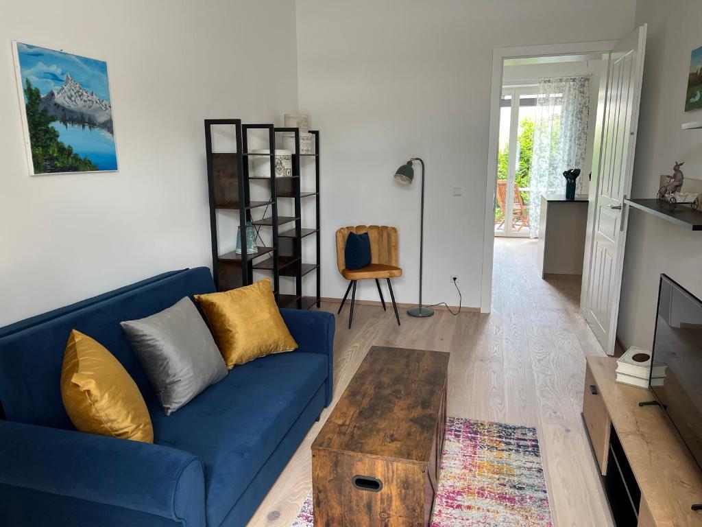 a living room with a blue couch and a coffee table at CityLife InApartment Salzburg in Salzburg