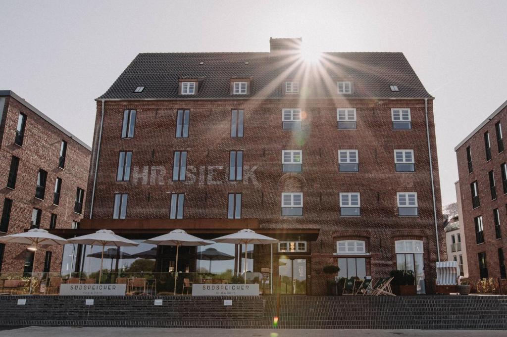 a large brick building with umbrellas in front of it at Südspeicher in Kappeln