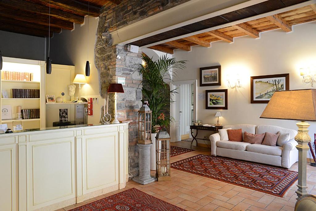 a living room with a couch and a kitchen at Hotel Borgo Antico in Como