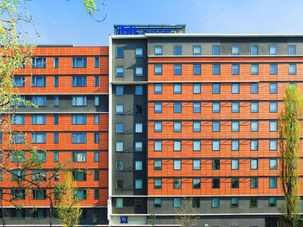 dwa budynki apartamentowe w pomarańczowym kolorze w obiekcie Ibis Budget Paris porte de la Chapelle - Aréna w Paryżu