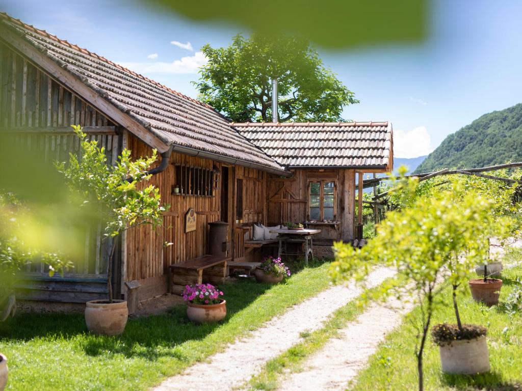 a small wooden house with a table in front of it at Arzenhof, Baron Di Pauli in Caldaro