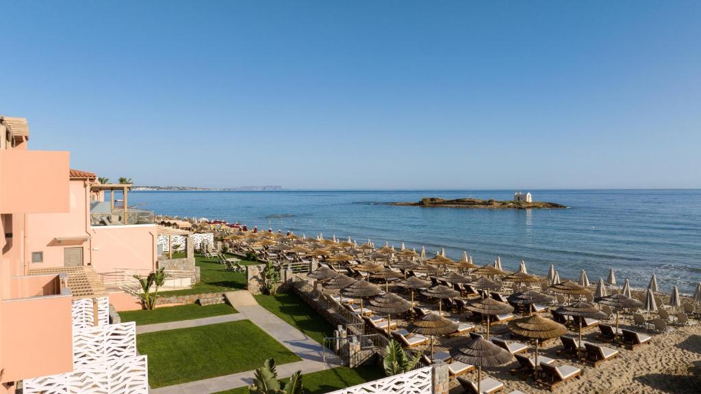 a view of the beach with umbrellas and the ocean at High Beach Resort in Malia