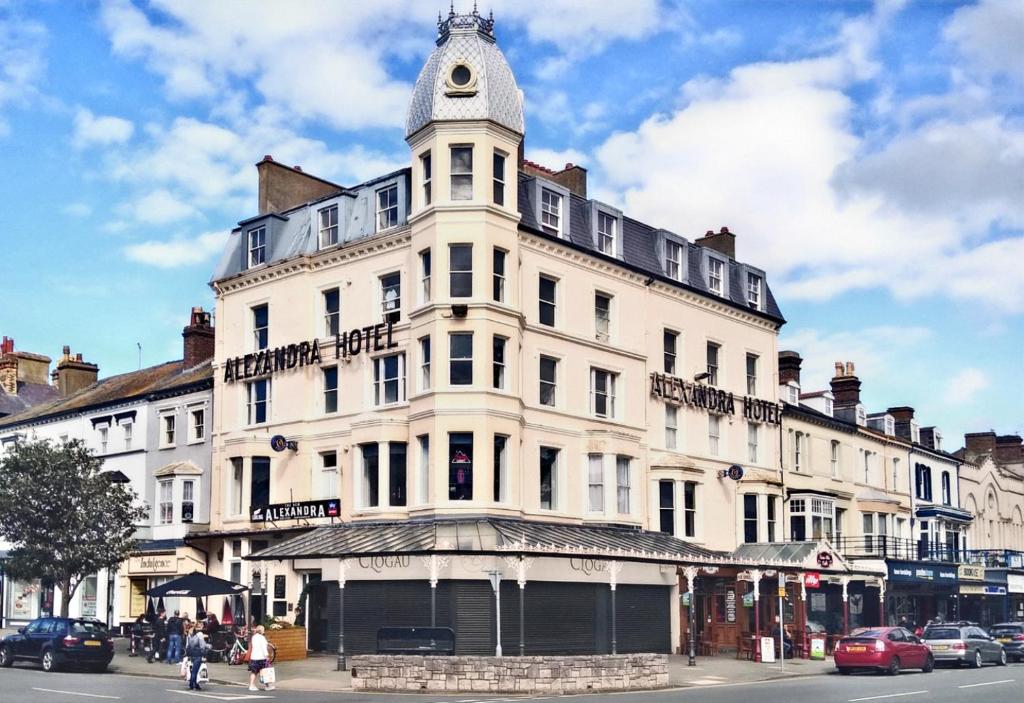 a large white building with a tower on top of it at The New Alexandra Hotel in Llandudno