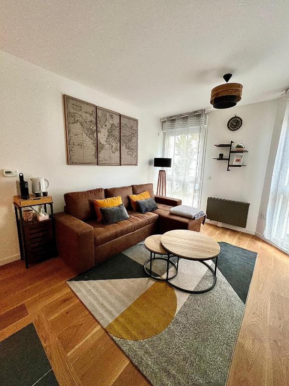 un soggiorno con divano e tavolo di New & serene 1-bedroom apart near #LaDéfenseParis #Parking&Fibre a Suresnes