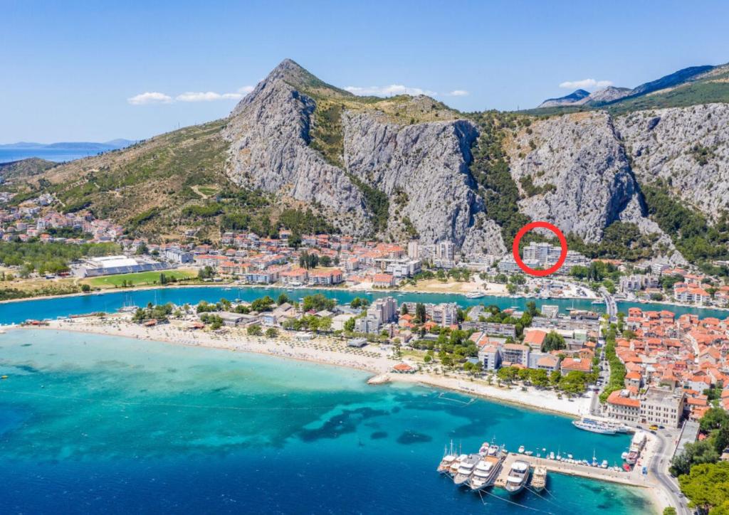 an aerial view of a resort on a bay with a red circle at Skyline Suite in Omiš