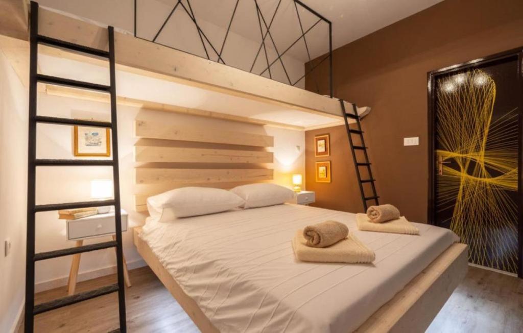 een slaapkamer met een stapelbed en 2 handdoeken bij Apartment Sanja- 25m from sandy beach in Duće