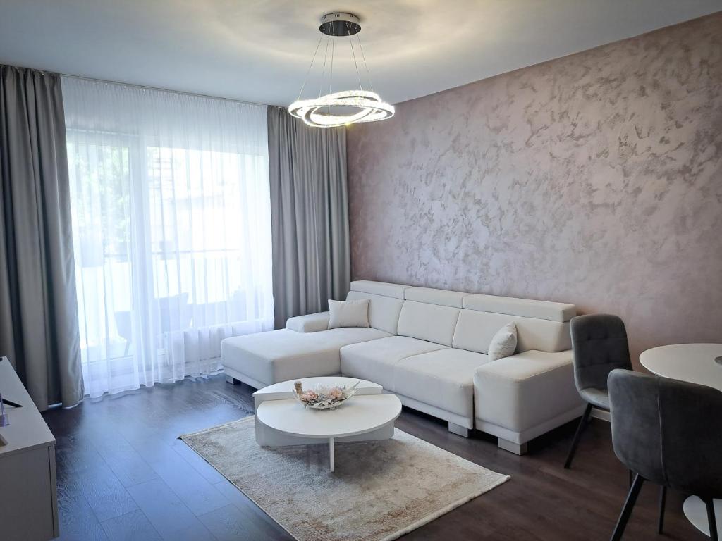 a living room with a white couch and a table at Tabáň Marble apartment (city center & free parking) in Nitra