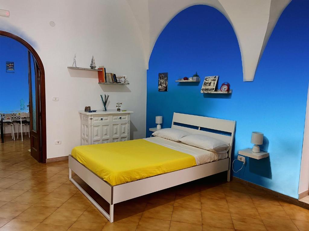 a bedroom with a bed with a blue wall at Maison Sosò in Naples