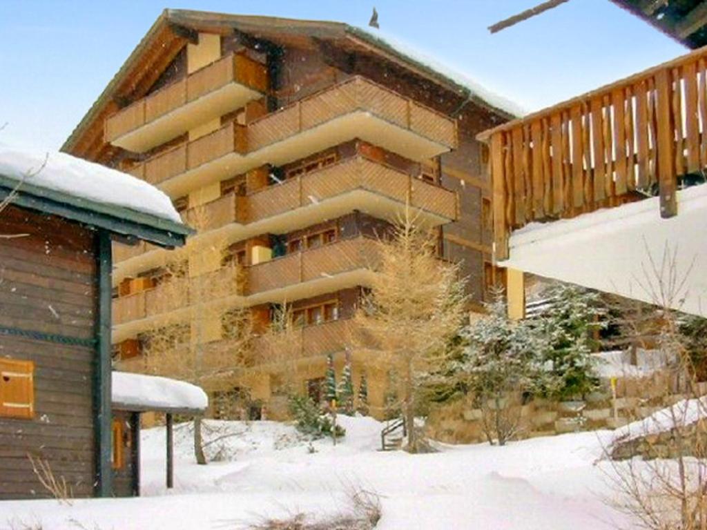 a large building with a balcony in the snow at Cosy Apartment in Bellwald 68 m² Mountain View in Bellwald