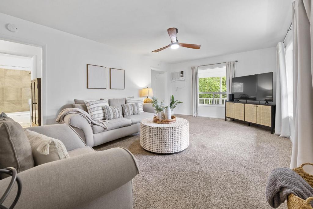 a living room with a couch and a tv at Sunrise - 1322 Indian Point Road in Branson