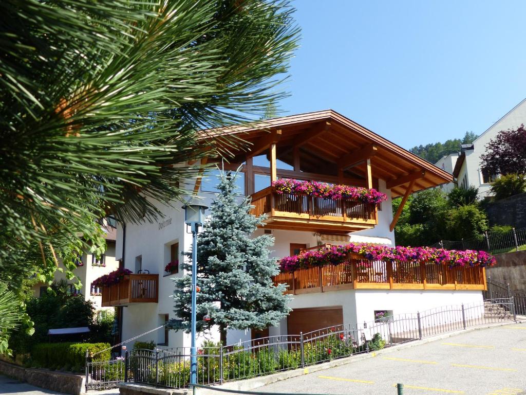 a building with flower boxes on the balconies at Apartments Dolomie in Ortisei