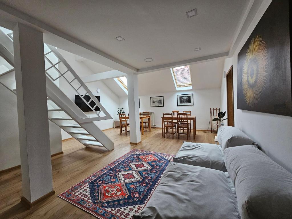 a living room with a couch and a staircase at Leopold Chillout Hostel in Sarajevo