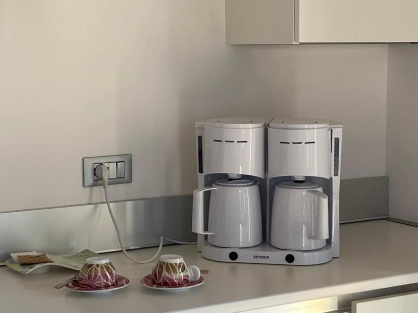 two coffee machines on a counter in a kitchen at Hotel Quarcino in Como