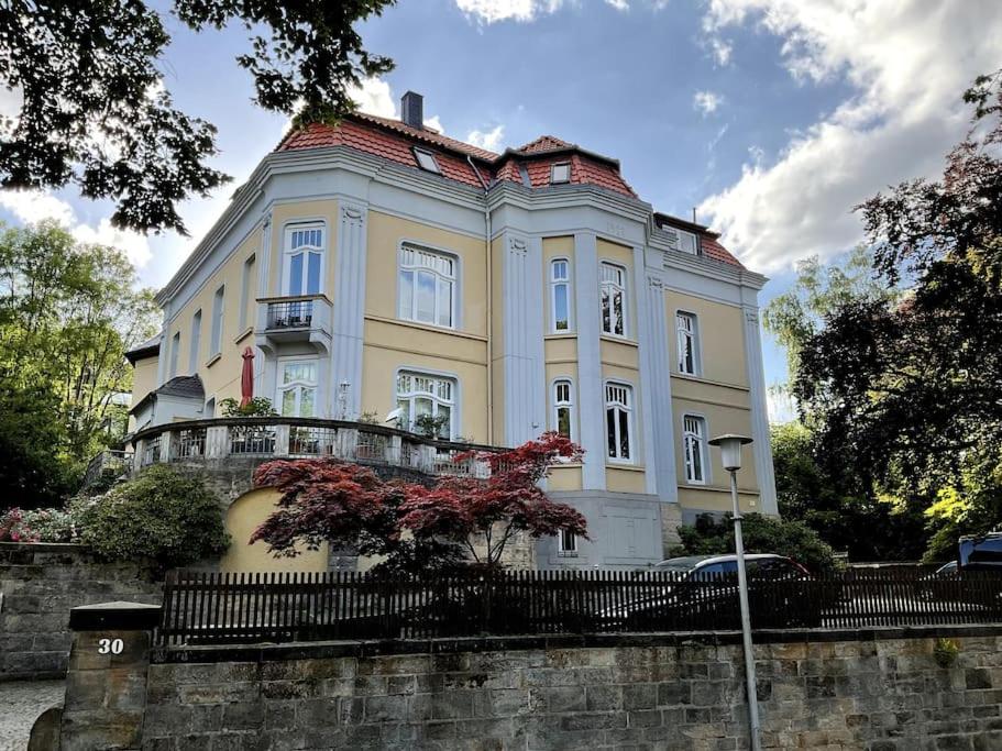 a large white house with a fence in front of it at 4 Zimmer Design Atelier Wohnung in Goslar