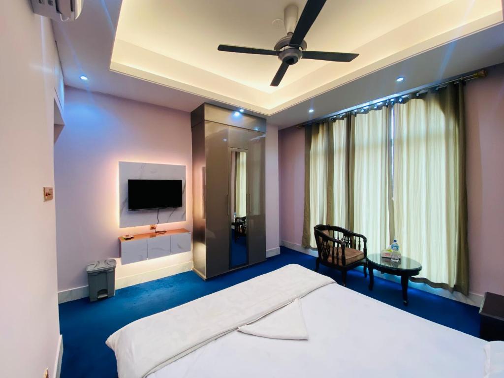 a bedroom with a bed and a flat screen tv at Hotel Grand Akther in Sylhet