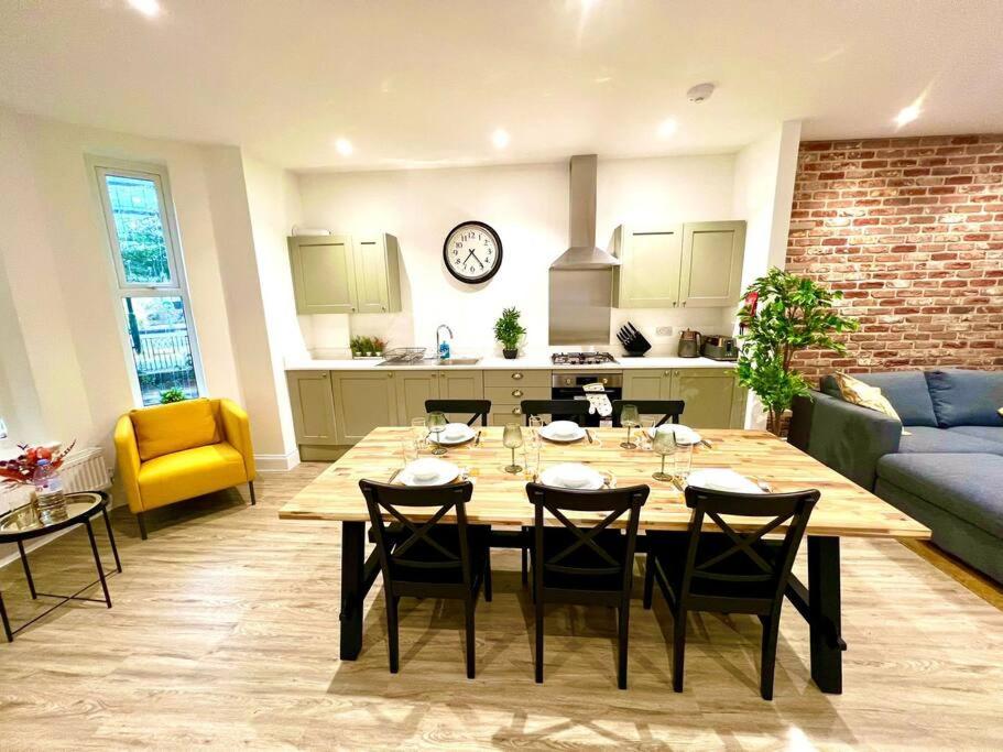 uma sala de jantar e sala de estar com mesa e cadeiras em Brand New Apt - Beach Breeze Spacious 1-Bedroom Apartment with parking - sleeps 4 ppl- internet em Bournemouth