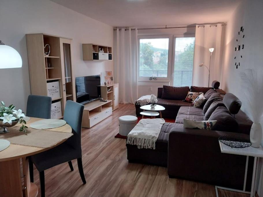 a living room with a couch and a table at Krásny apartmán v centre Rožňavy in Rožňava