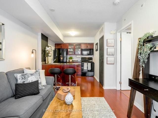 a living room with a couch and a table at Liberty Village Townhouse in Toronto