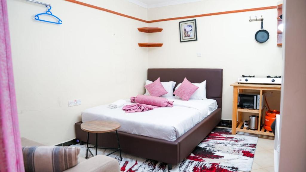 A bed or beds in a room at Shalom Apartments Naivasha