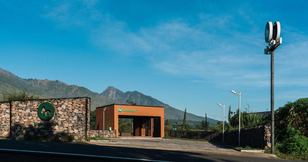 a building on the side of a road with mountains at Bobocabin Gunung Rinjani, Lombok in Sembalun Lawang