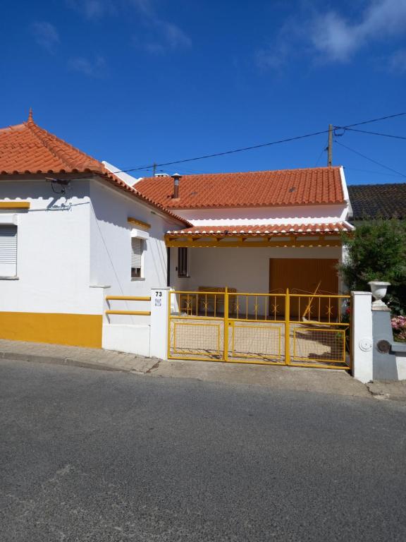 Casa blanca y amarilla con puerta amarilla en Casa d'Avó, en Araújo