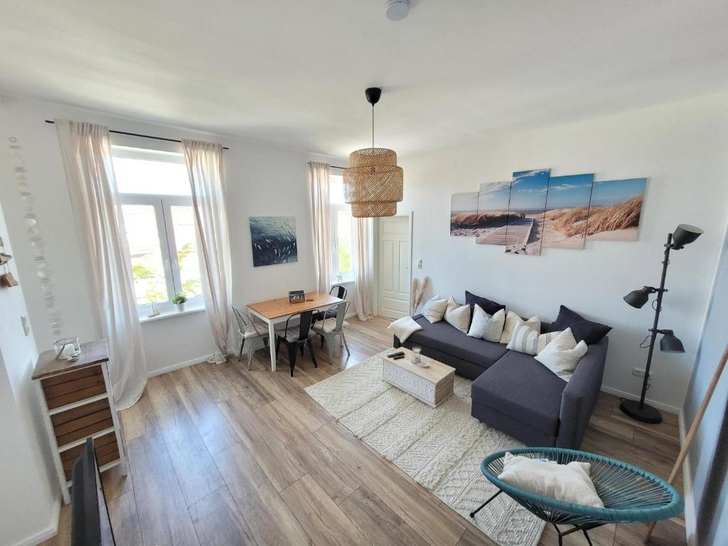 a living room with a couch and a table at Apartment mit beach flair in Garz-Rügen