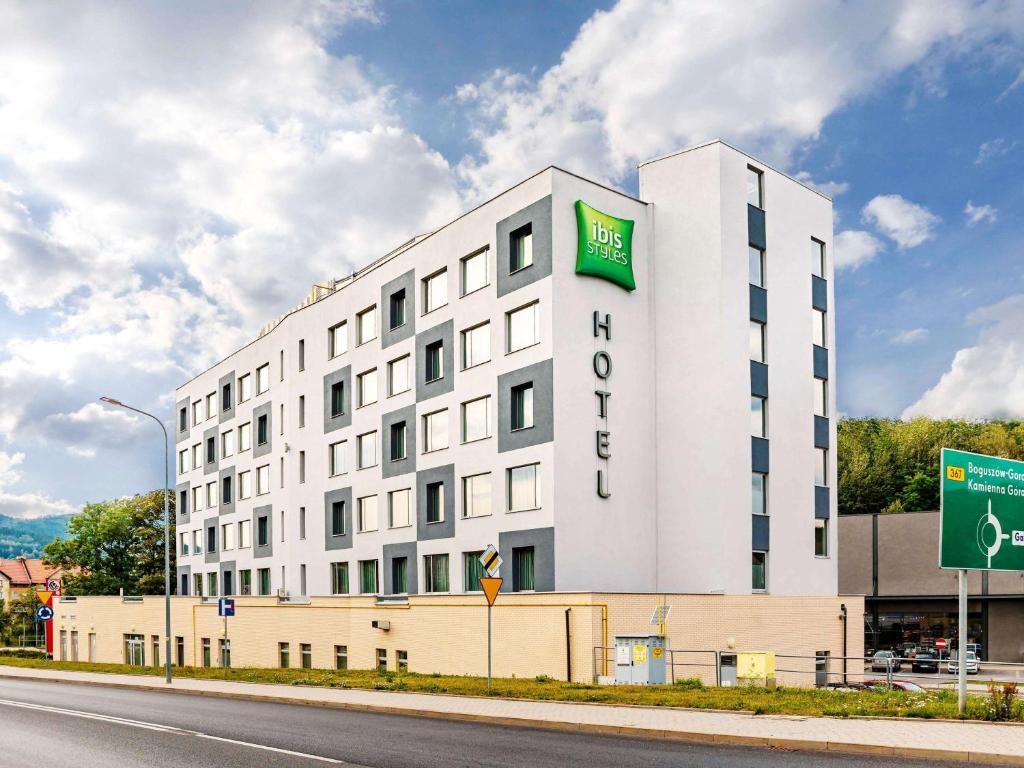 a white building with a sign on the side of it at ibis Styles Wałbrzych in Wałbrzych