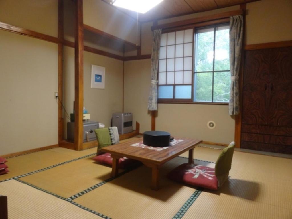 a living room with a table and chairs and a window at Shinyu Onsen Kurikomaso - Vacation STAY 04615v in Kurihara