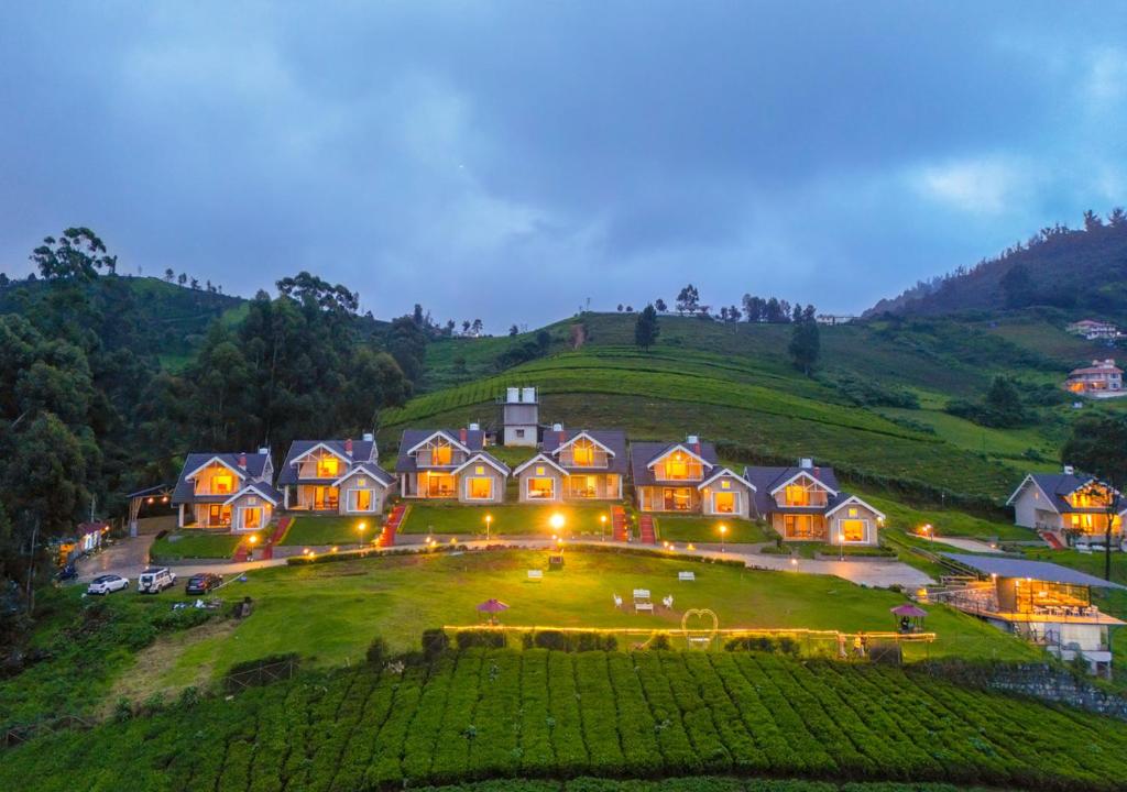 een groot huis op de top van een heuvel 's nachts bij AJ Gable Clouds Ooty by VOYE HOMES - Serene Stay Near Avalanche Emerald Lake in Ooty