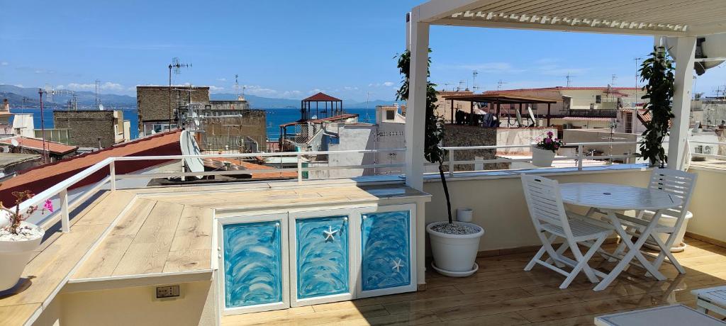 a balcony with a table and a view of the ocean at The Sorabellas in Gaeta