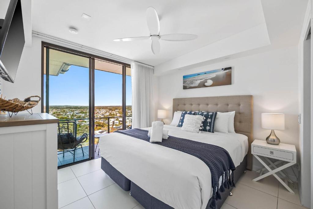 a bedroom with a large bed and a balcony at Nova Mooloolaba Beach Apartments in Mooloolaba