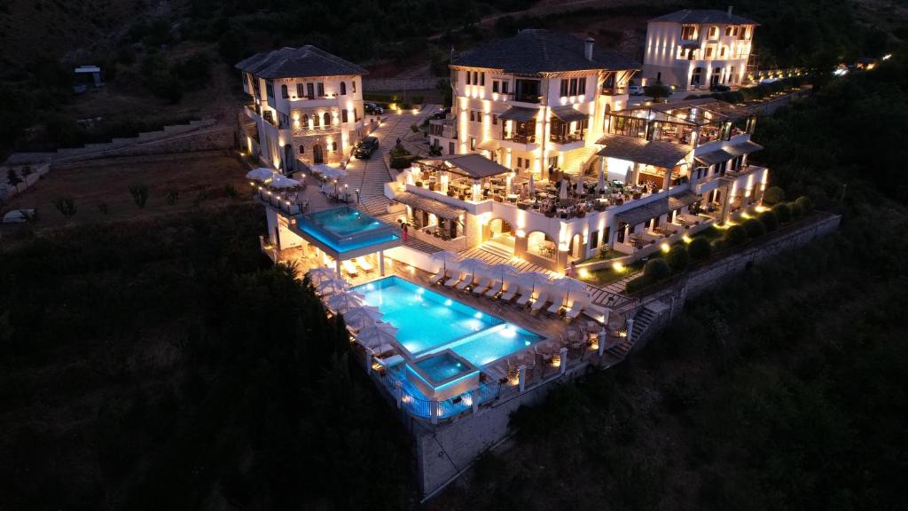 - une vue aérienne sur une demeure de caractère dotée d'une piscine la nuit dans l'établissement KERCULLA Resort, à Gjirokastër